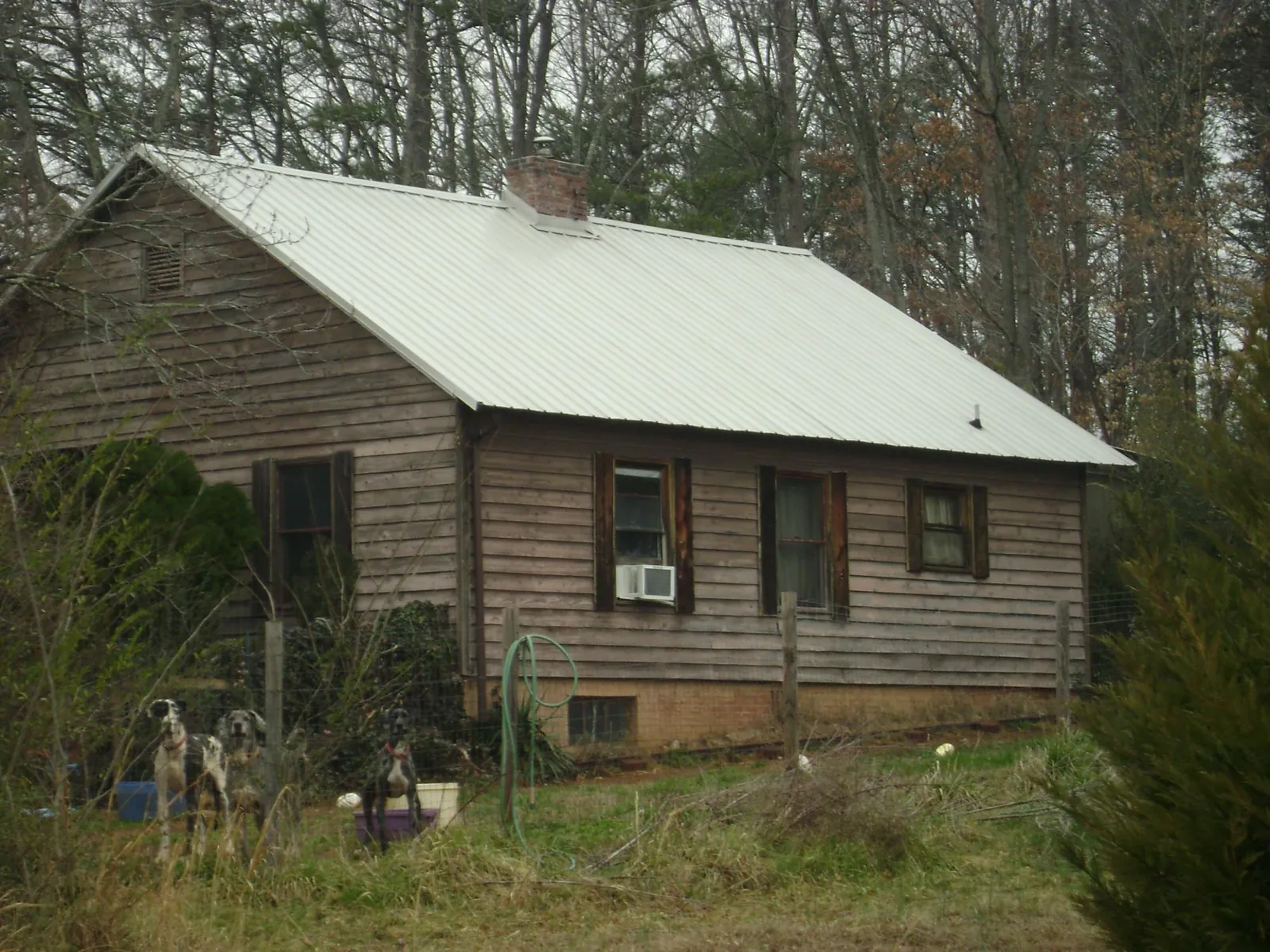 White metal roof on an old wood sided farmhouse, from a Metal Roof Installation job in Yatesboro